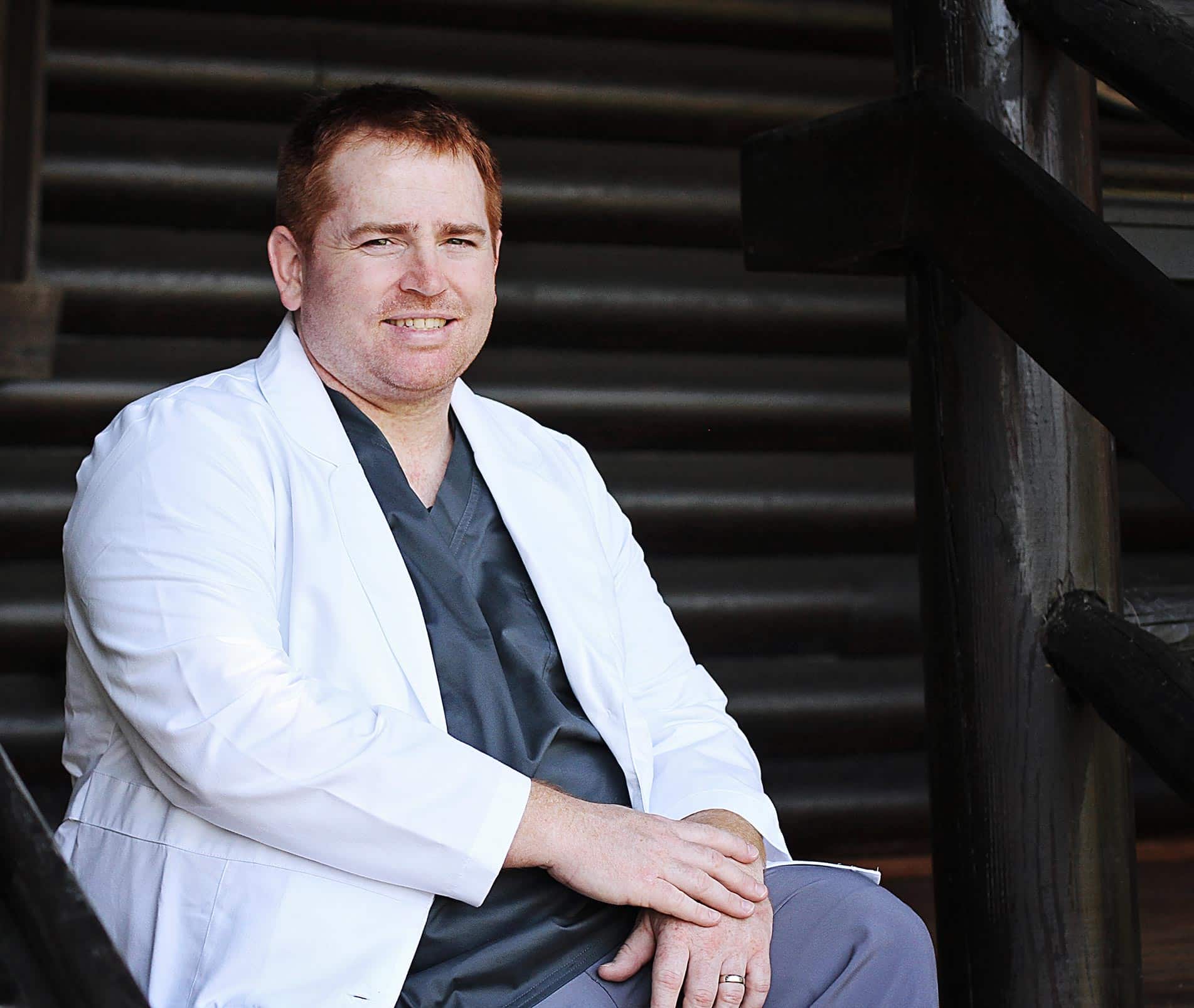 Dr. Kanetsky smiling in front of cabin